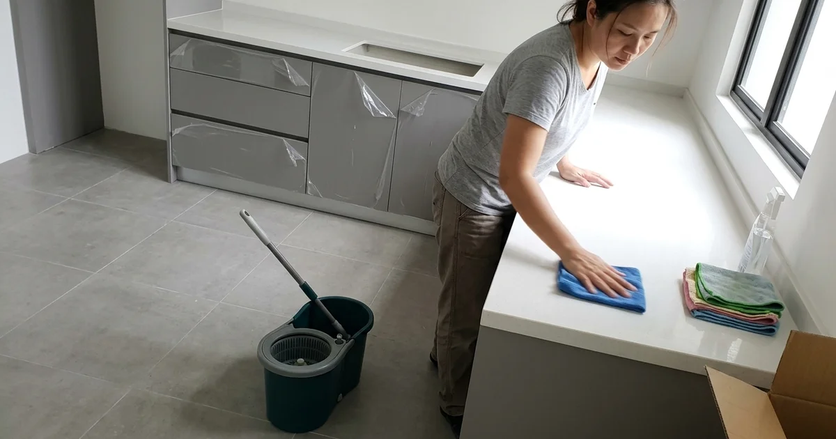 Cleaner sanitising an empty new home before move-in
