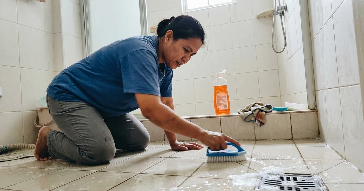 Cleaner scrubbing tile grout during a deep clean