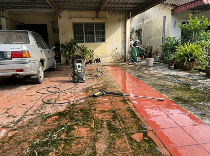 Car porch half cleaned by pressure washing